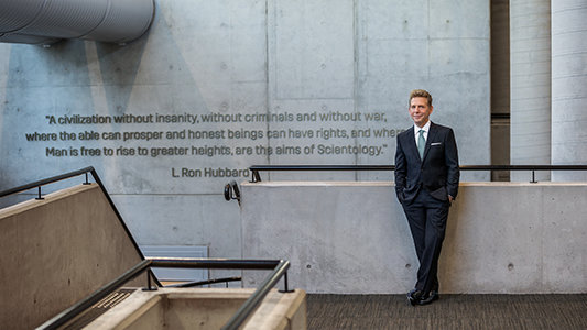 David Miscavige in Sydney, Australia, Aims of Scientology quote on wall behind him