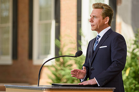 David Miscavige in Atlanta, Georgia, at podium, hand gesturing