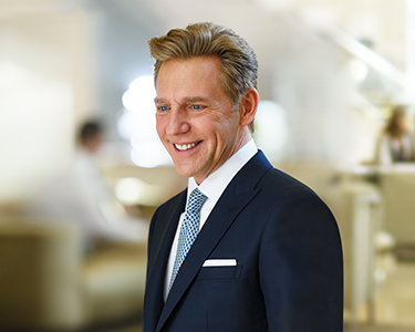 David Miscavige portrait in blue suit, smiling
