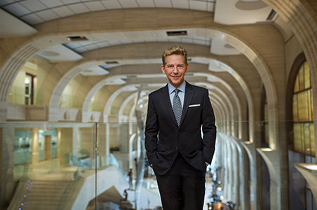 David Miscavige in Clearwater, Florida, medium, hands in pockets over Flag Building Grand Atrium