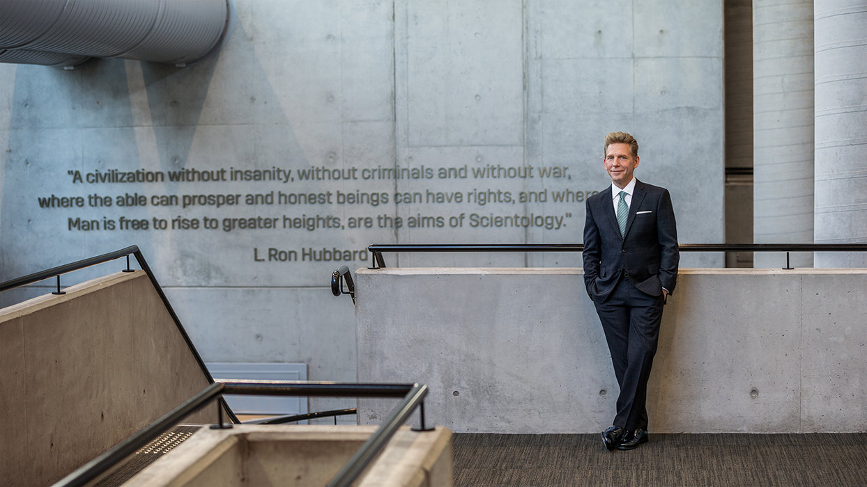 David Miscavige in Sydney, Australia, Aims of Scientology quote on wall behind him