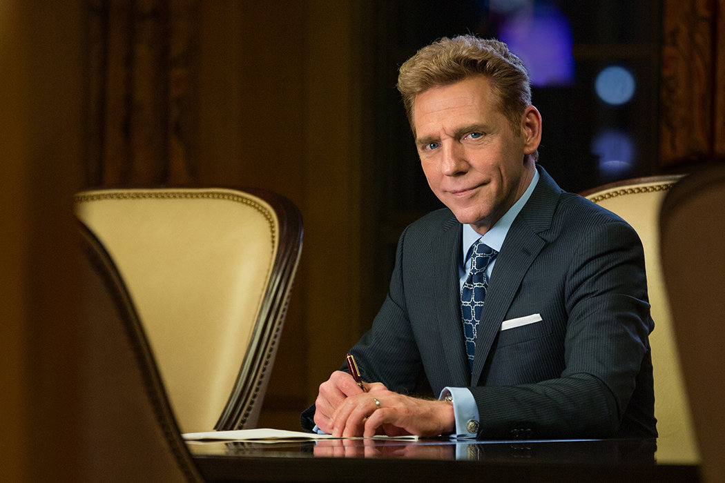 David Miscavige sitting at conference table signing papers<br/>