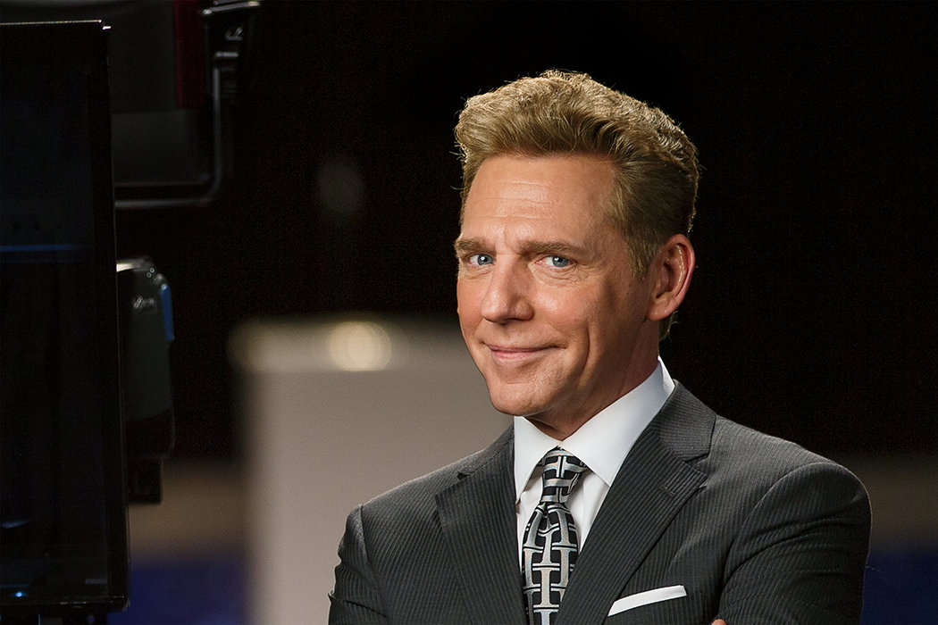 David Miscavige in Hollywood, California, close-up, wearing dark gray suit next to camera in studio