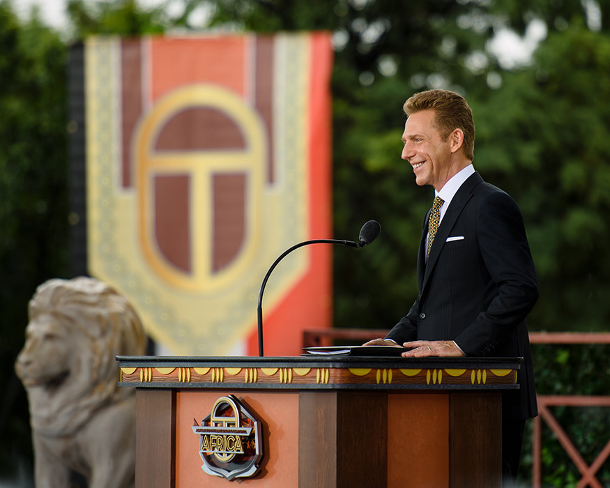 David Miscavige in Johannesburg, South Africa, at podium in black suit